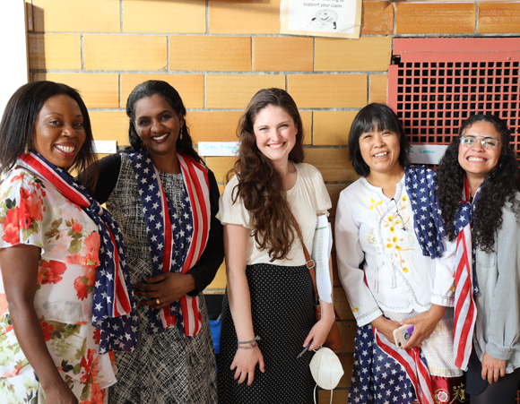 Five English as a New Language students standing next to one another, smiling.