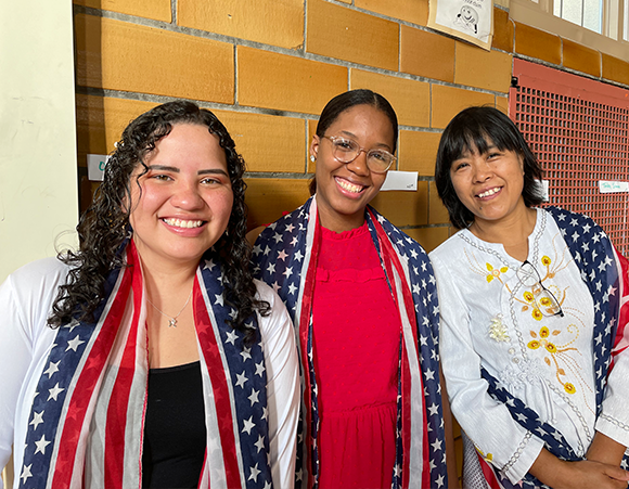 Three English as a New Language students after their graduation