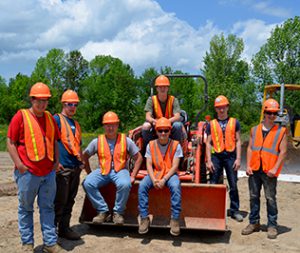 Students sitting on a front end loader