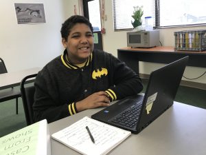 A student smiles in class.