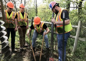students dig a hole