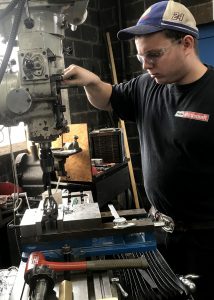 Capital Region BOCES’ Manufacturing & Machining Technology student Chris Zaunter works on a machine at a manufacturing business.