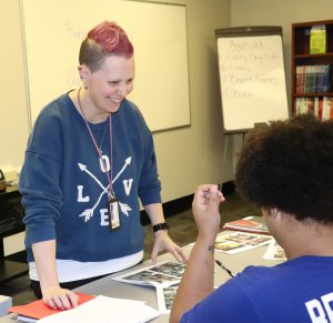 Literacy Zone Teacher Heather Rozmierski works with a student on a reading lesson.