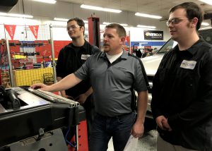 Automotive Trades Technology Teacher Brian Lacroix with students run a diagnostic test on a vehicle at the Career and Technical school. 