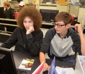 BOCES' Internet Application Design students Daniel Moore and Kody Lieb work side by side at a computer. 