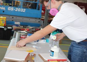 Capital Region BOCES Auto Body Student Tim DeCelle demonstrates his painting skills.