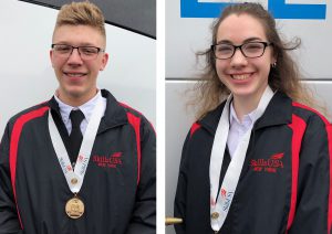 Career and Technical School students Brian Sydney and Megan O'Toole, wearing blue and red SkillsUSA jackets and first place medals, smile for the camera after a recent competition.