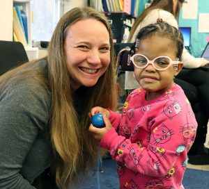 Capital Region BOCES Physical Therapist Julianne student and her young student smile for the camera.