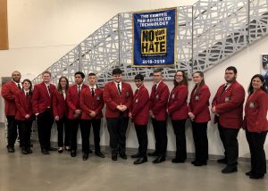 New SkillsUSA officers from the Capital Region BOCES Career and Technical School pose as a group wearing red blazers and black pants.
