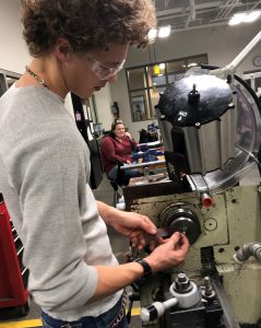 Drew Wideman works on a machine in a Capital Region BOCES Manufacturing and Machining classroom.