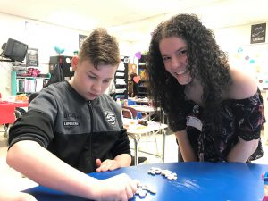 Two Capital Region BOCES' students pause during a team-building activity to smile for the camera. 