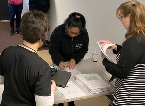 An Adult Nursing student receives a computer for online learning during the COVID-19 school closures.