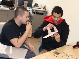 Two students in the Capital Region BOCES Engineering Technician program work together to build a balsa wood airplane as part of a class project. 