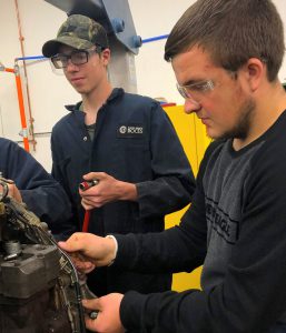 Jacob Newell learns with classmate prior to the school closure in a Capital Region BOCES' diesel tech classroom.