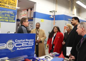 Automotive Trades Technology teachers talk in a Creer and Technical School auto classroom with New York State Corrections leadership.