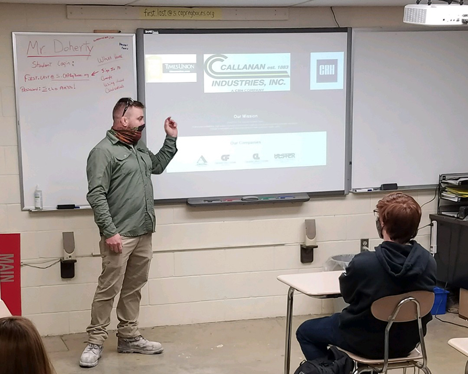 An adult from Callanan Industries presents in the front of the classroom