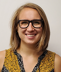 Jaime Gibbs, CVLA guidance counselor, who has shoulder length blond hair and is wearing black horn rimmed glasses and a yellow sleeveless blouse, looks at and smiles for the camera.