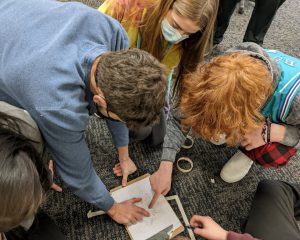 Group of three students work together on a project