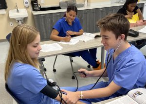 Students practice taking blood pressure