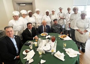 Group photo of 10 culinary students with Andrew Joyce and Congressman Paul Tonko and two individuals.