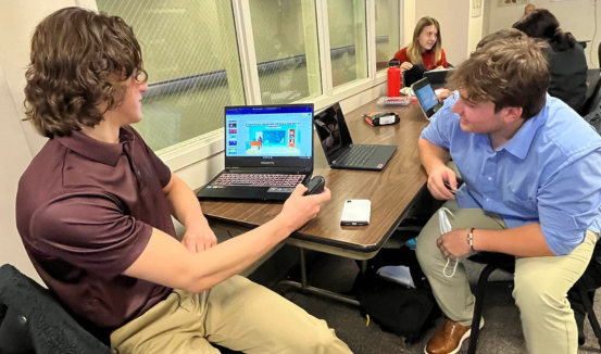 A nursing student practices taking a patient's blood pressure.