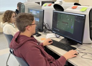 Two students, Carissa Stern and Zachary Casso sitting in front of computers.