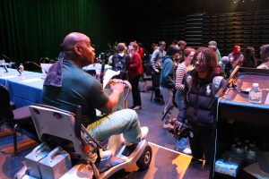 Michael Arterberry, speaks to a student off the stage.