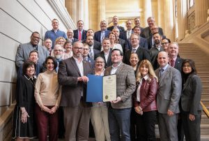 BOCES district superintendents gather around the 75th anniversary proclamation 