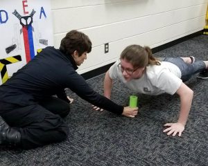 two student crouched on floor