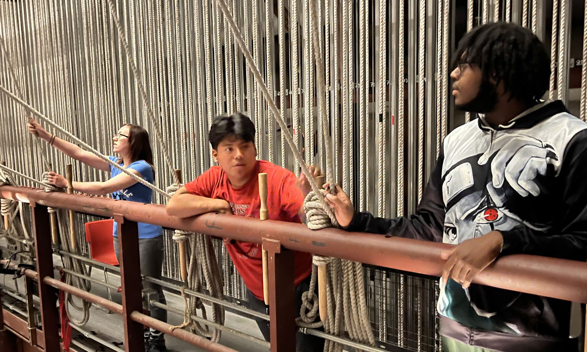 Three students stand backstage at Schenectady's Proctors Theatre.