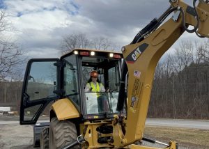 Someone operating a back hoe.