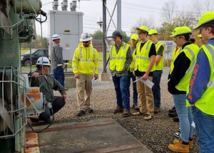 A group of students from Schoharie BOCES watch over an exercise at a National Grid site.
