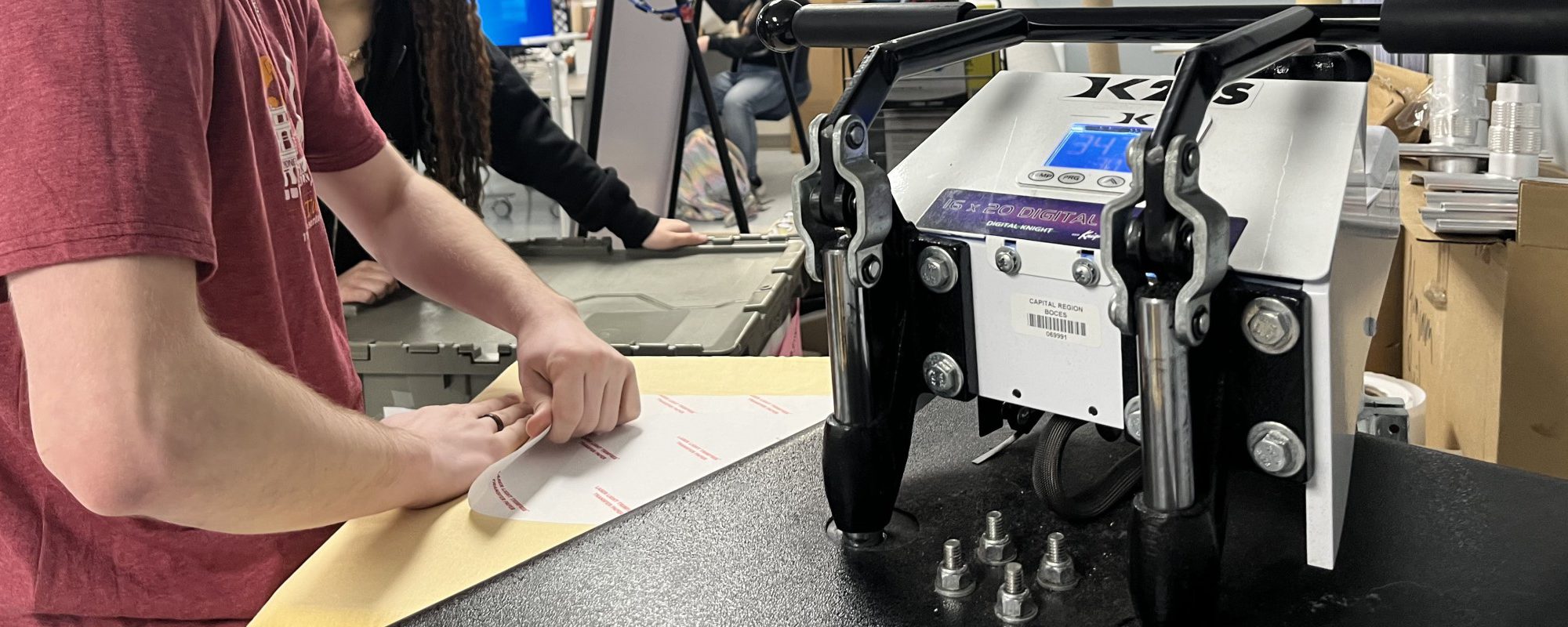 A student works at preparing a print for a T-shirt.