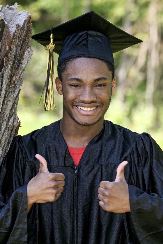a graduate gives two thumbs up