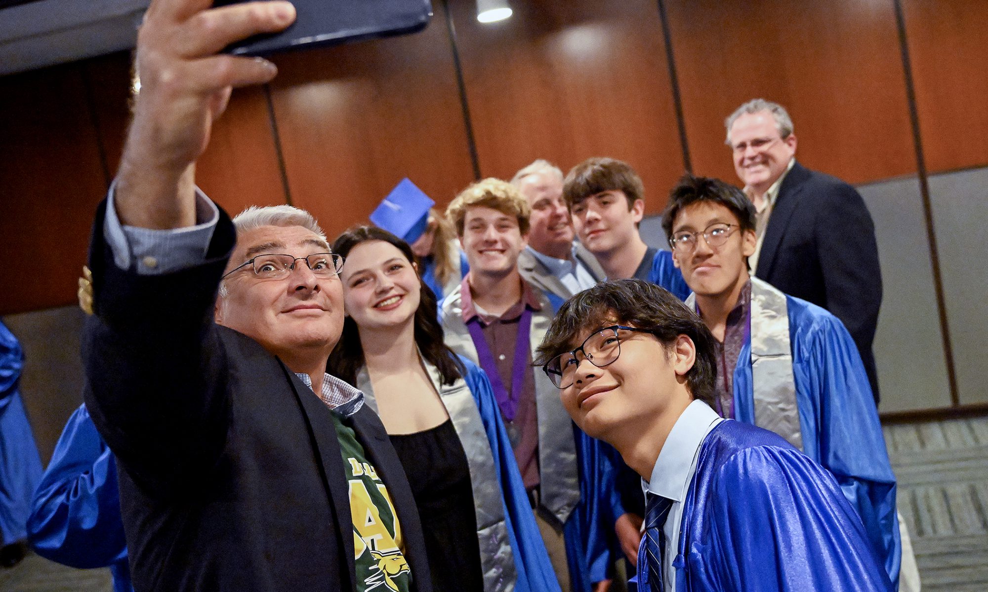 Graduates gather for a selfi.