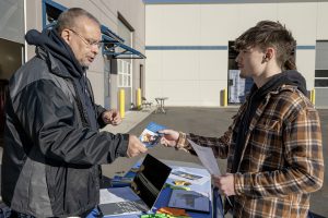 Nick Sparzo, Cohoes senior, speaks with William Bolger, Training Director at Tri-City Joint Apprenticeship and Training Committee Inc for Electrical Industry, during Capital Region BOCES careers in construction month