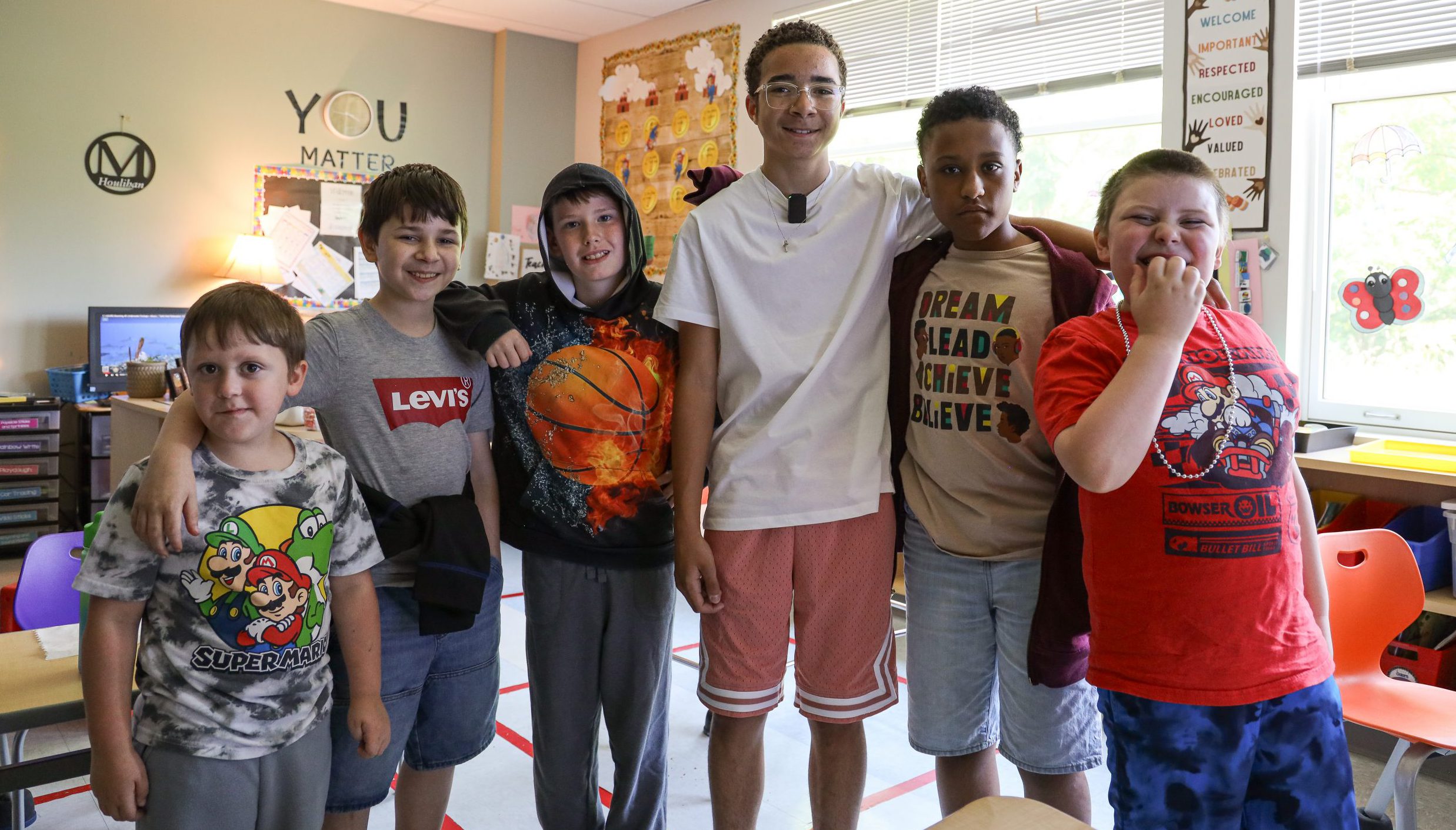 five students pose and smile