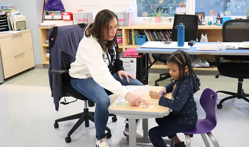 a teacher works with a student