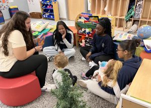 students reading to young kids