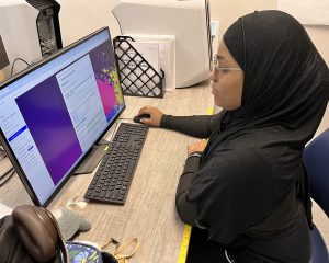 A student wearing a hajib at the computer