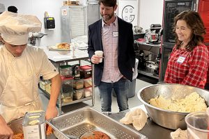 counselors observe a young scholar making food