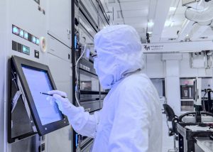 A student gauges a measurement in a bunny suit