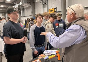 A recruiter speaks with students