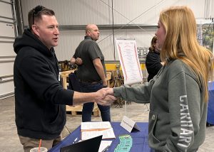 An employer and student shake hands