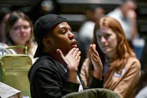 A student uses his hands to make emphasis on his point.
