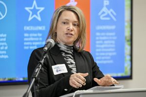 A board member speaks at the podium.