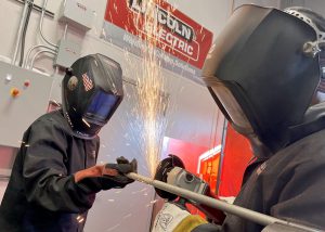 Two students weld