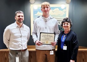 Student poses with Matt Ward and Nancy Liddle