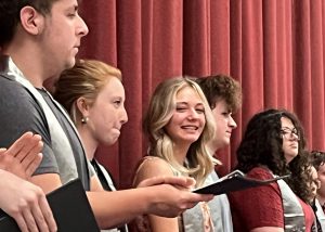 Girl smiles from stage