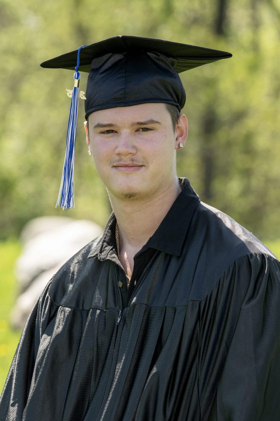 A photo of Maywood Academy graduate Jacob Bilicki in his cap and gown.
